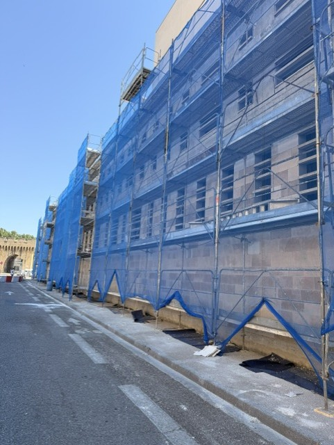 Échafaudage bâché le long de la façade de l'Hôtel de police d'Avignon